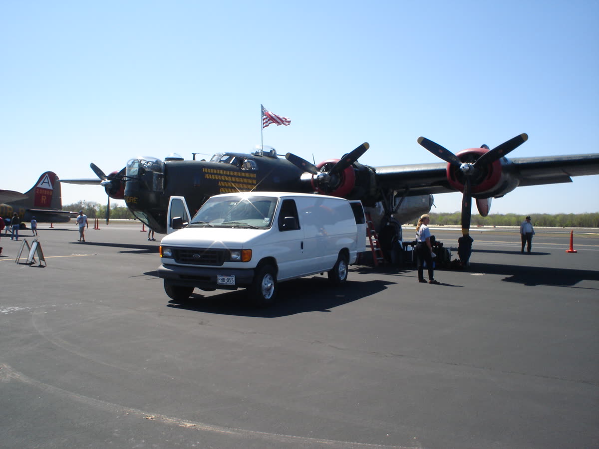 Bahan Aviation Services mobile maintenance van beside a B-24 Liberator on the ramp
