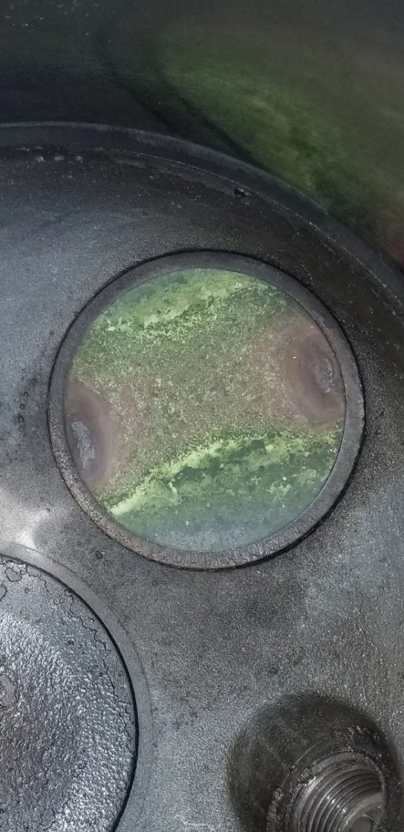 Burned and warped exhaust valve seen during a cylinder borescope inspection